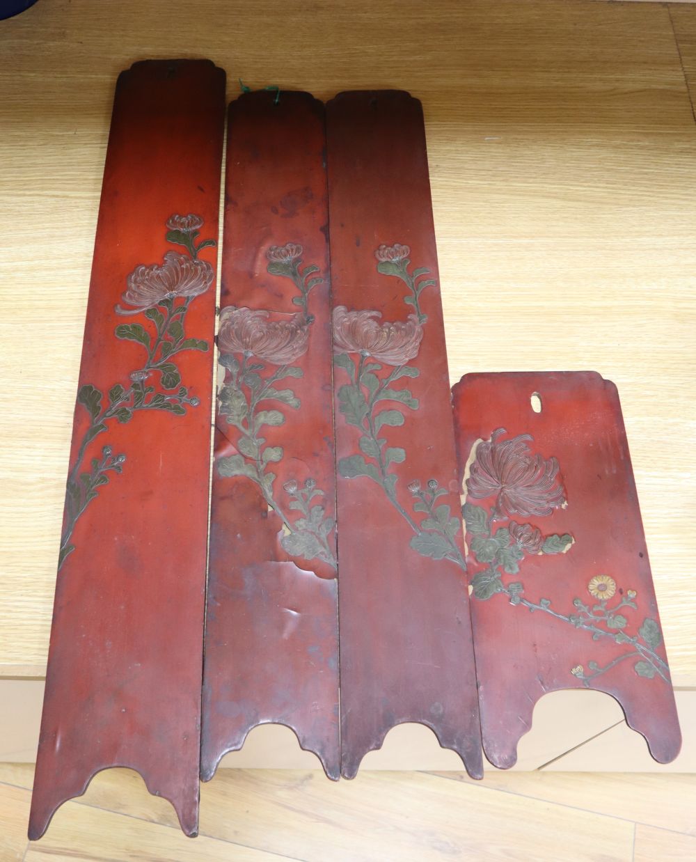 Four Japanese red lacquered hardwood panels, decorated with chrysanthemums, largest panel height 79cm